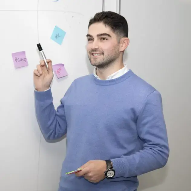 An Oaklin consultant presenting ideas at a whiteboard